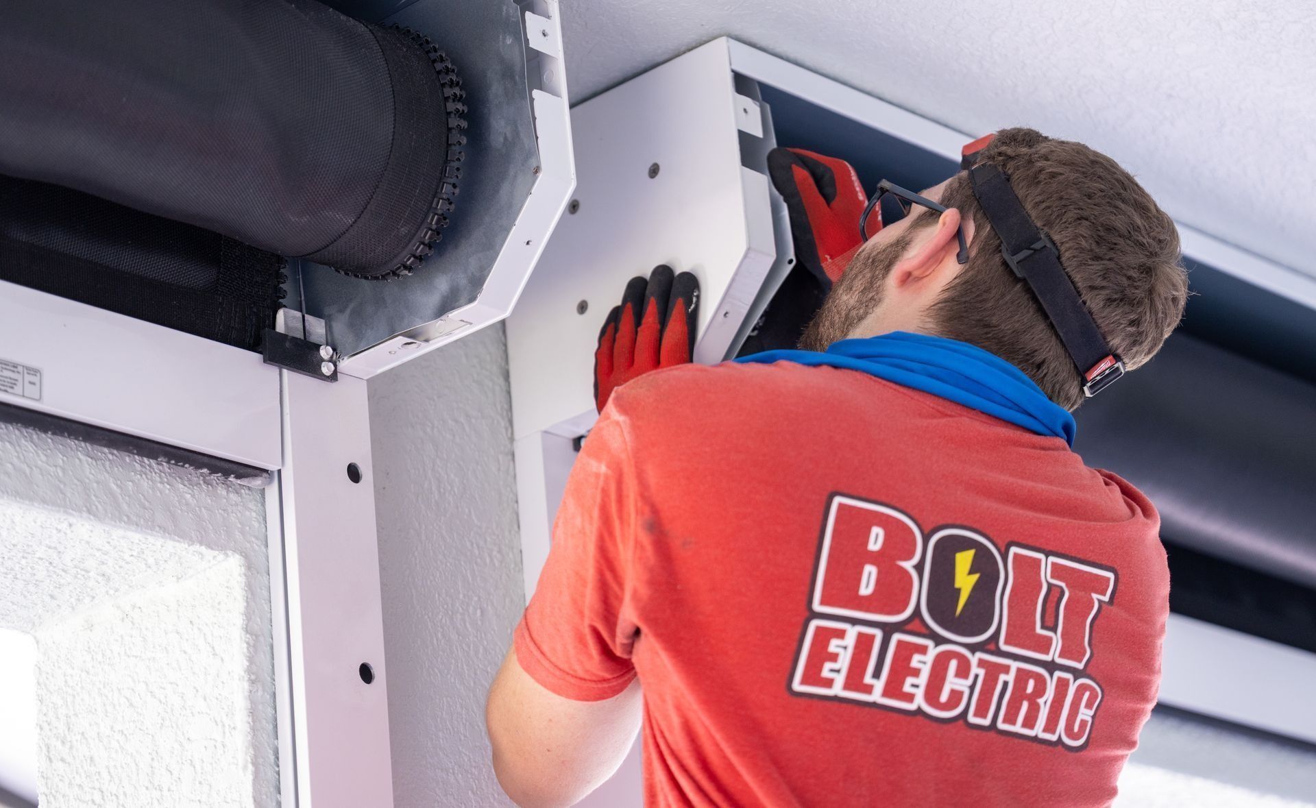 An electrician installing components.