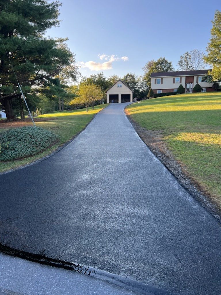 a driveway leading to a house with a garage .