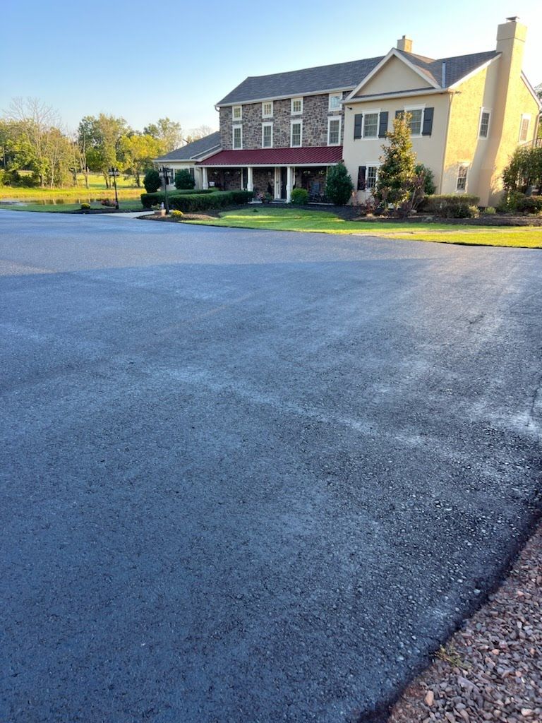 a large house with a large driveway in front of it .