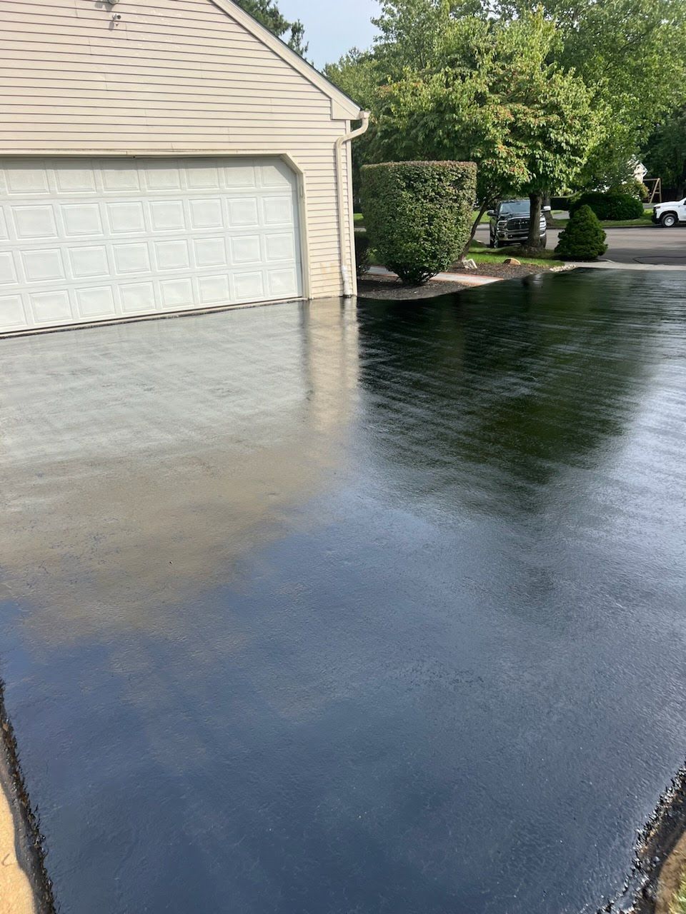 a black driveway with a garage in the background .