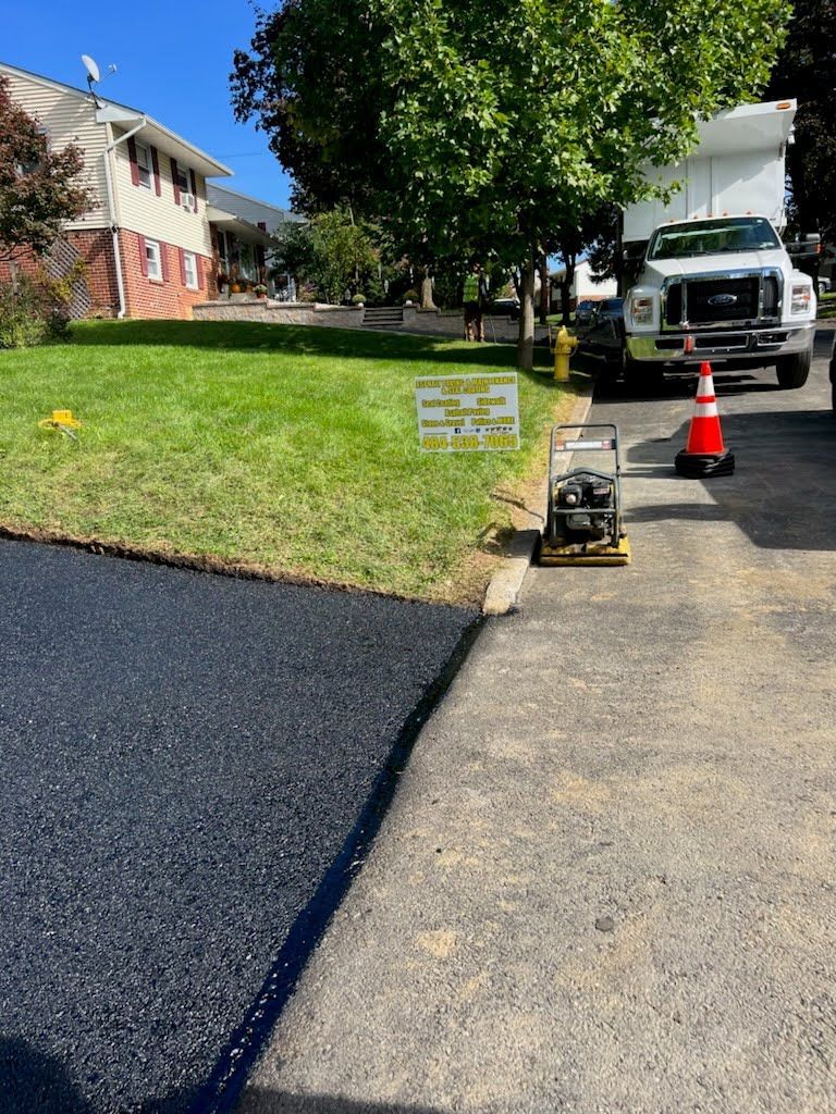 a truck is parked on the side of a road next to a house .