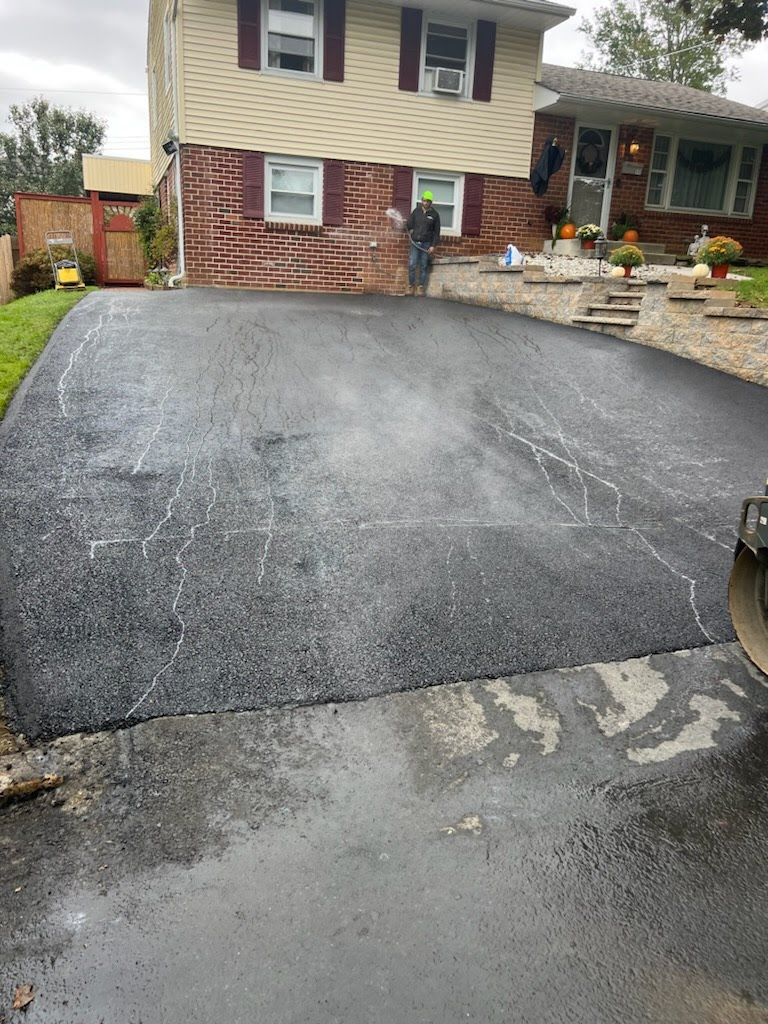 a man is standing in a driveway in front of a house .