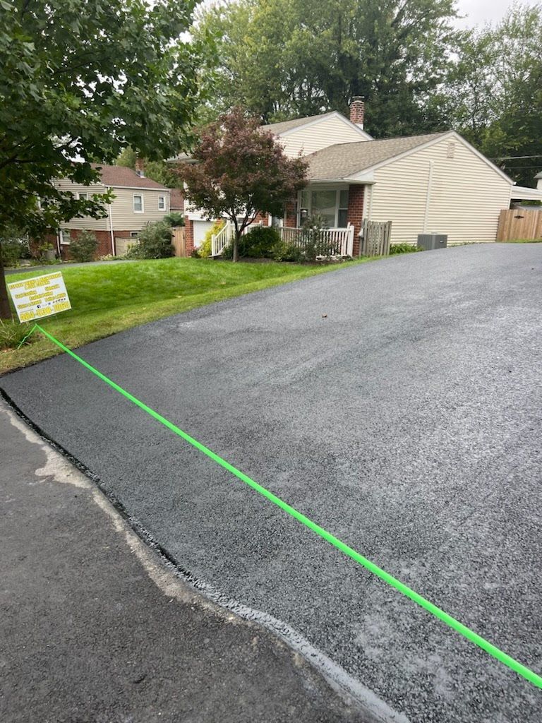 a green line is being used to measure the width of a driveway .