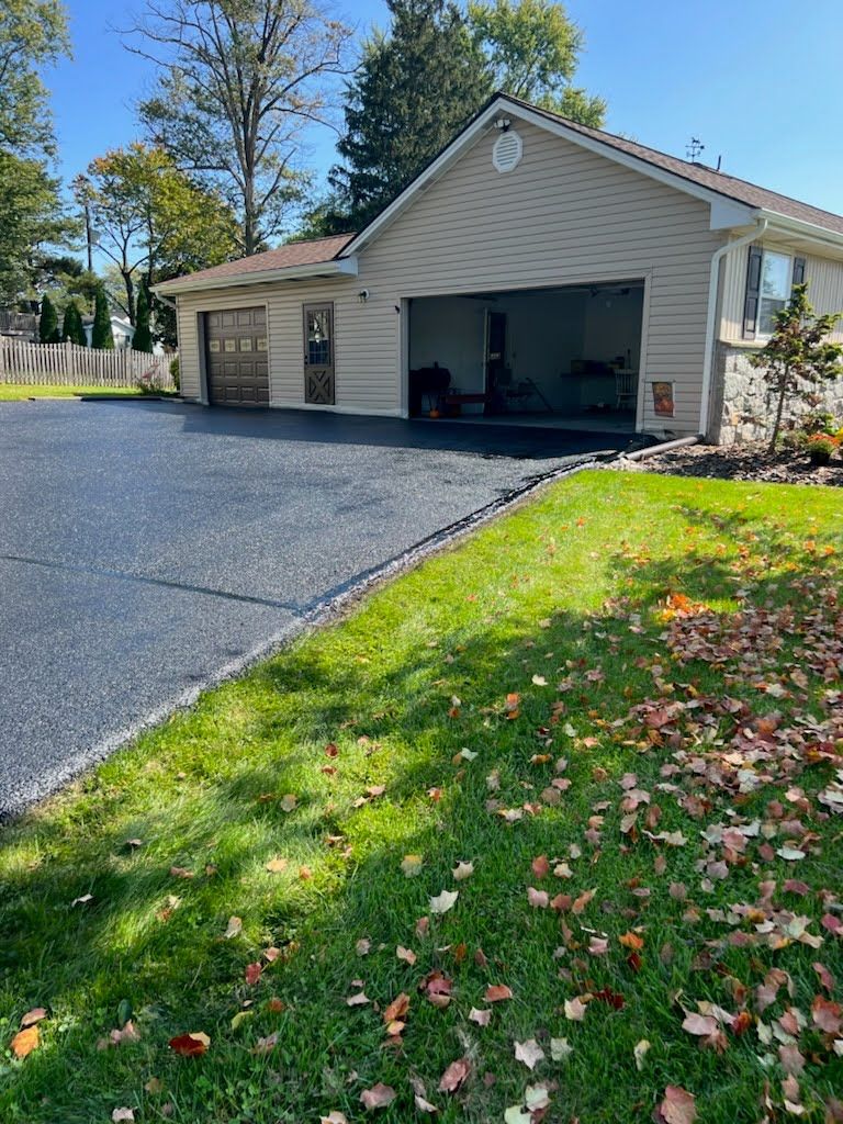 a house with a garage and a driveway in front of it .