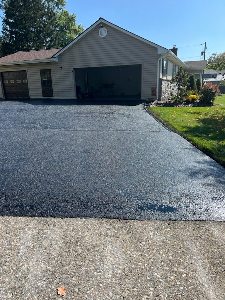 a house with a driveway that has been paved in front of it .