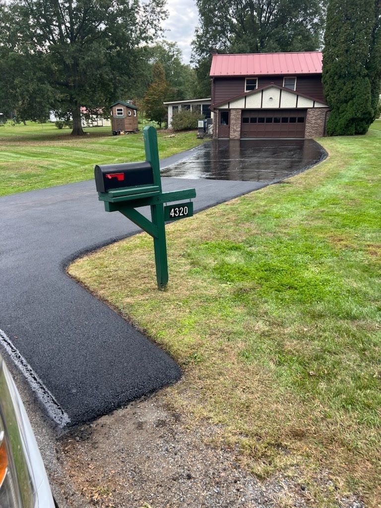 a mailbox is sitting on the side of a road next to a house .