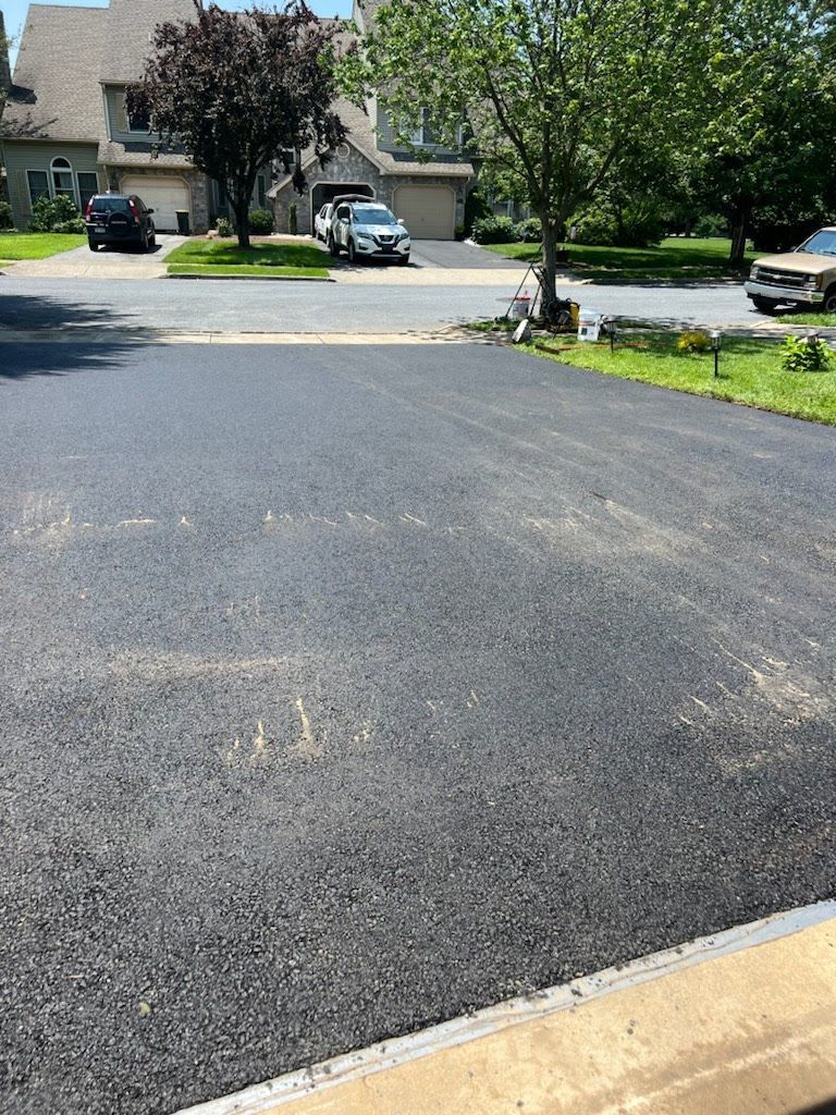 a car is parked in a driveway next to a house .