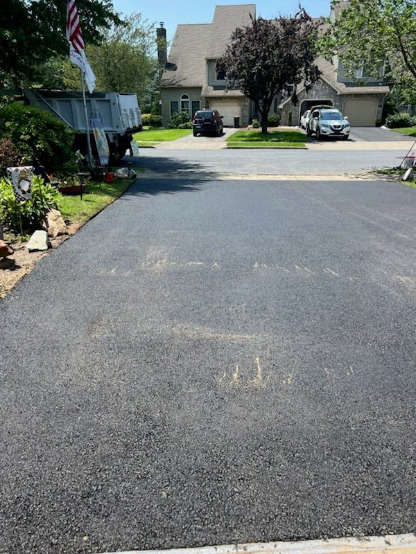 a newly paved driveway in a residential neighborhood