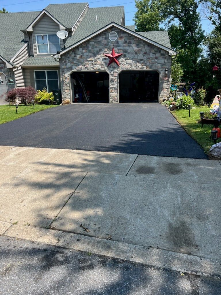 a driveway in front of a house with a red star on the garage door .