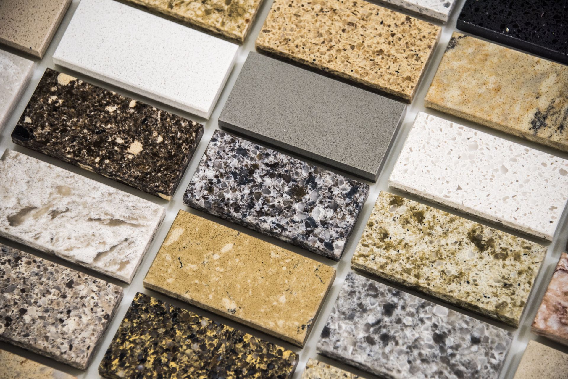 Samples of various countertop materials in different colors and textures.