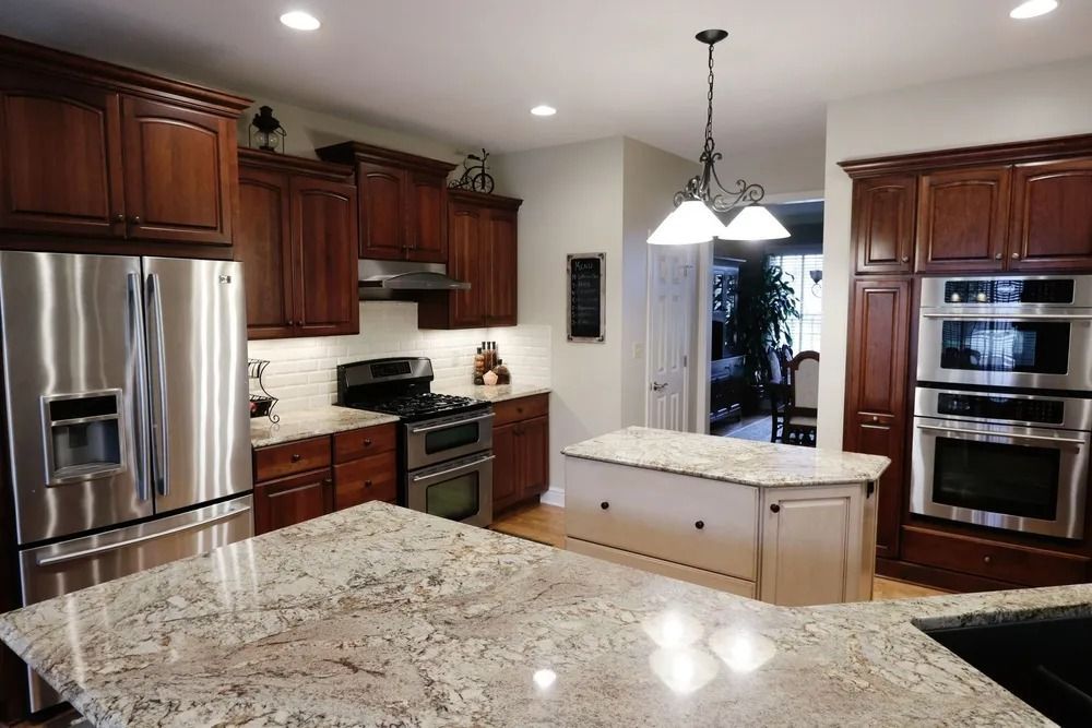 Kitchen with brown cabinets, stainless steel appliances, and granite countertops.