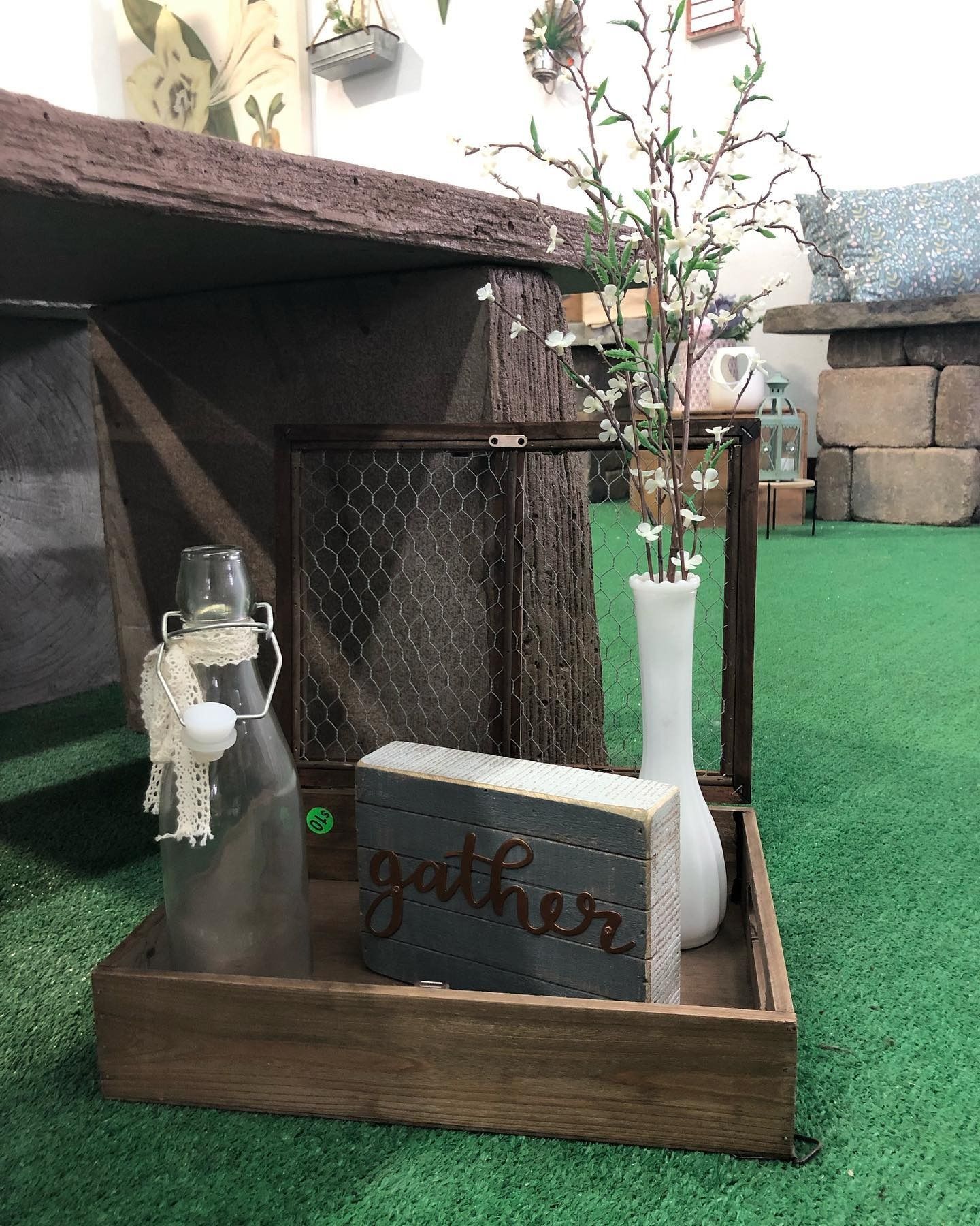 A wooden tray with a glass bottle, a 