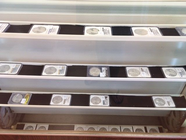 A row of shelves with black and white coins on them