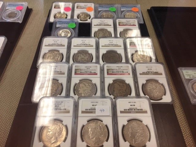 A bunch of coins in plastic cases on a table