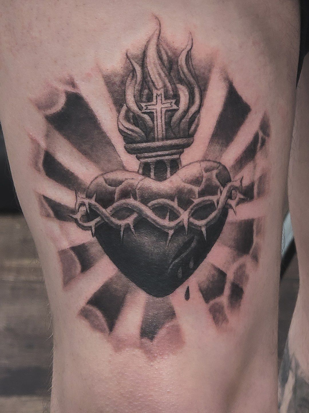 Tattoo of a heart with thorns and a cross