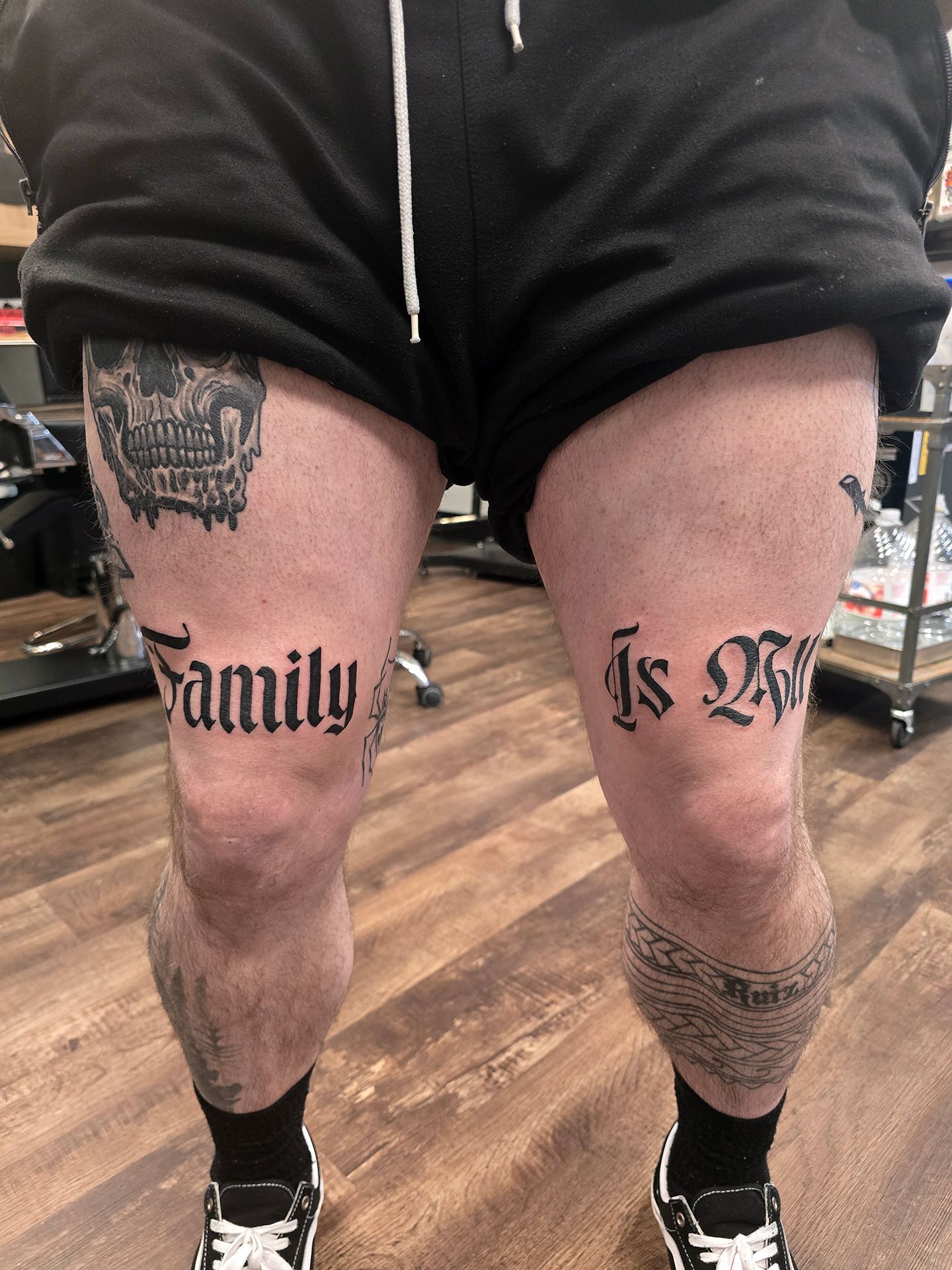 Text tattoo on both thighs