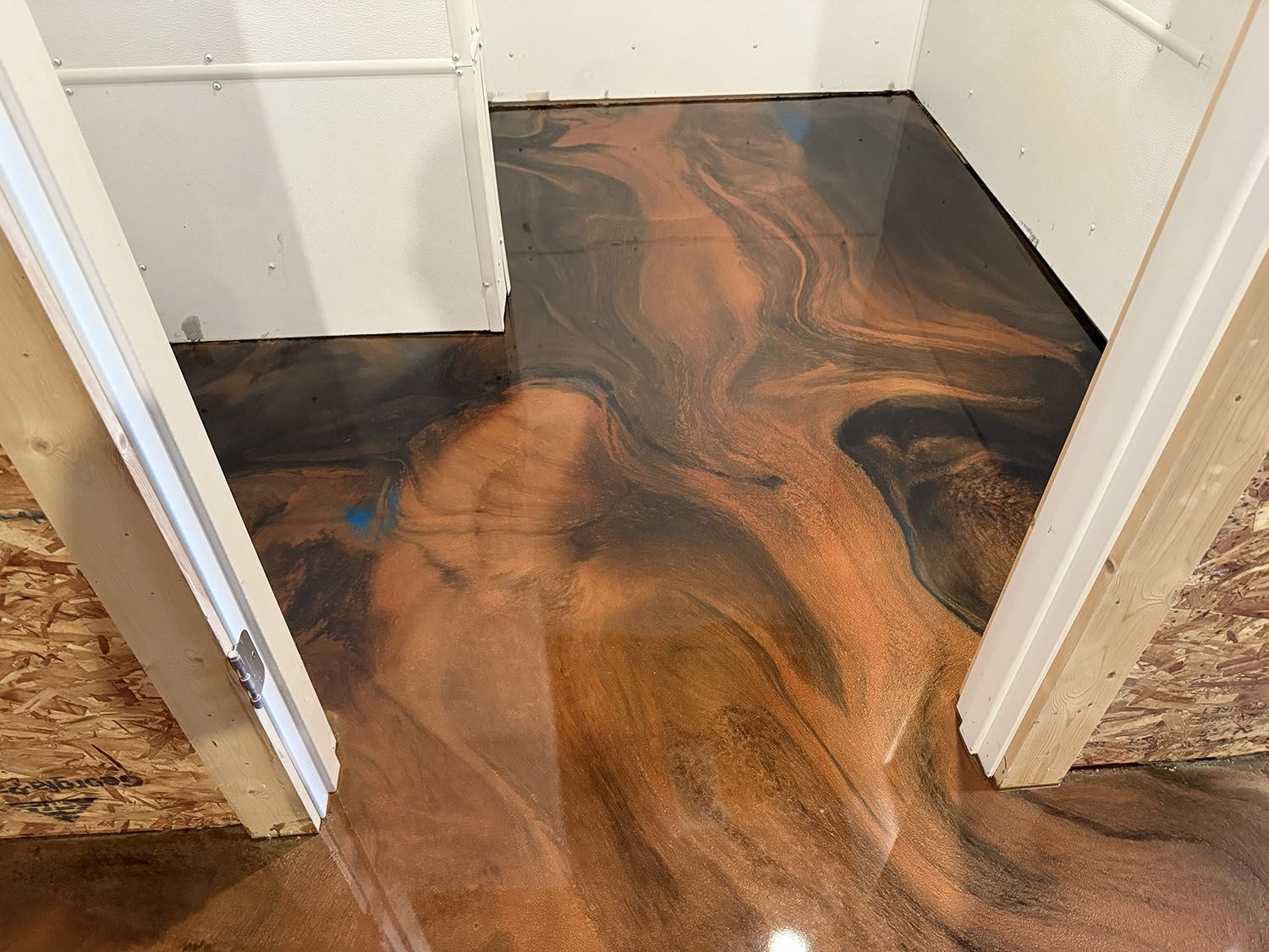 Flooded hallway with dark water swirling over a wood floor between doorways.