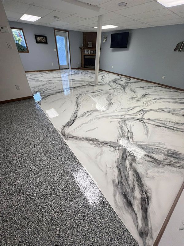 Modern room with glossy white marble-look floor and gray speckled carpet border, wall-mounted TV, and open doorway