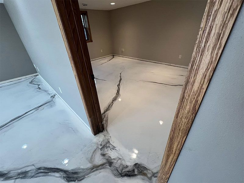 Marble-floored hallway with dark veining and brown door frames in a modern home