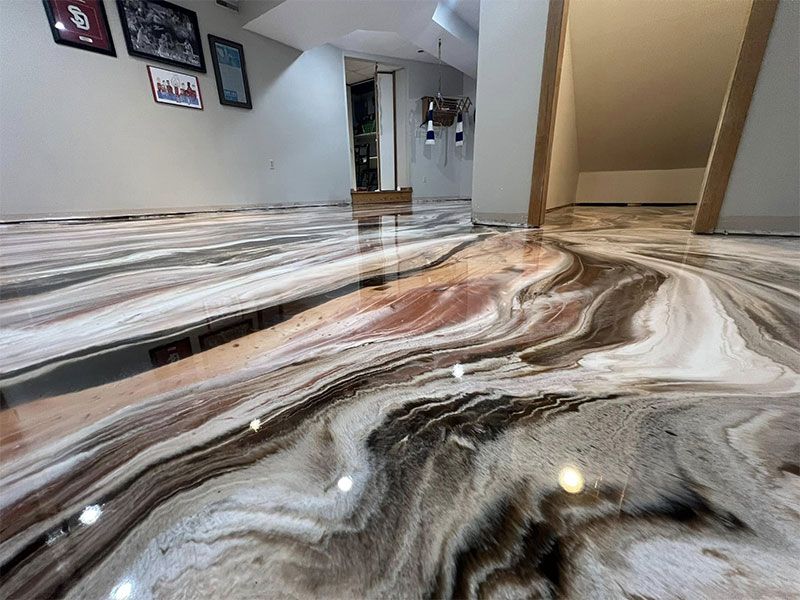 Marble-look floor in a modern hallway with swirling white, gray, brown, and pink tones