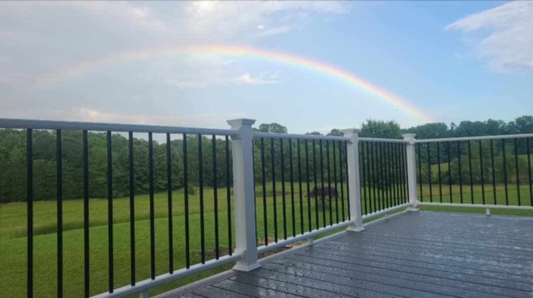 A deck with a rainbow in the sky behind it