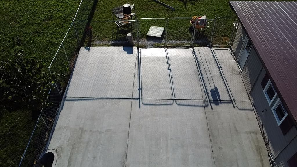 An aerial view of a concrete patio in front of a house.
