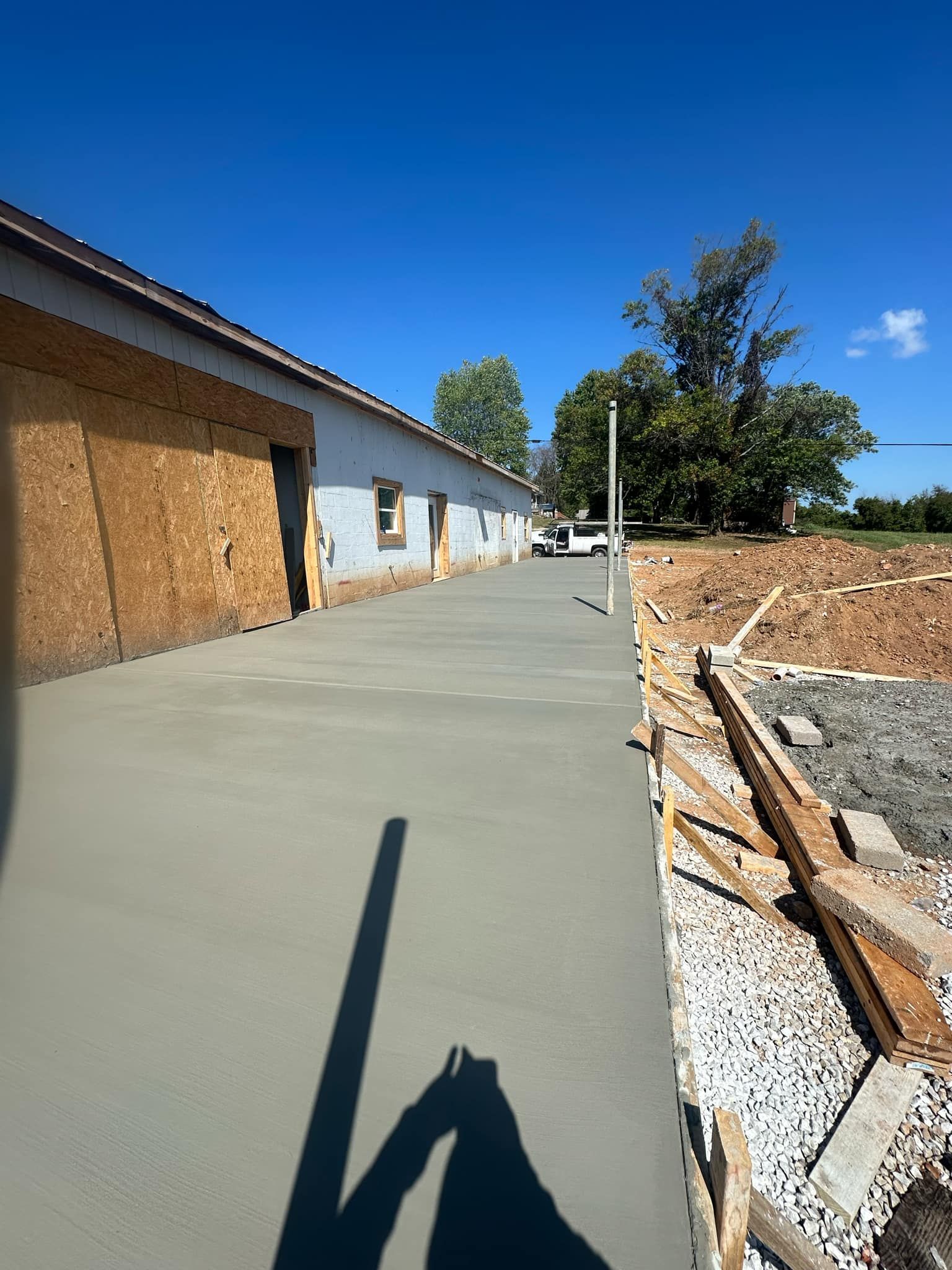 A person is taking a picture of a concrete walkway between two buildings.