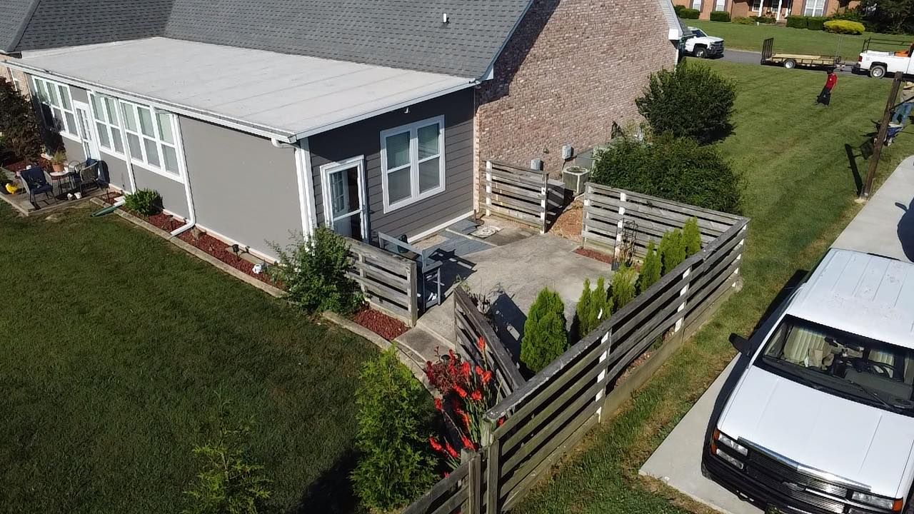 An aerial view of a house with a white van parked in front of it.
