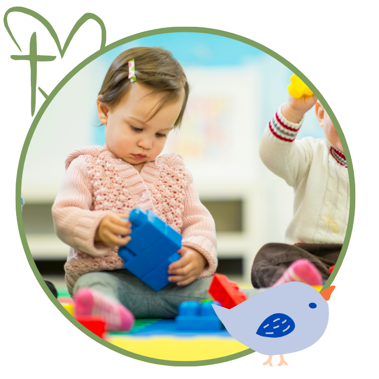 Toddler playing with blocks in a daycare setting; other child nearby.