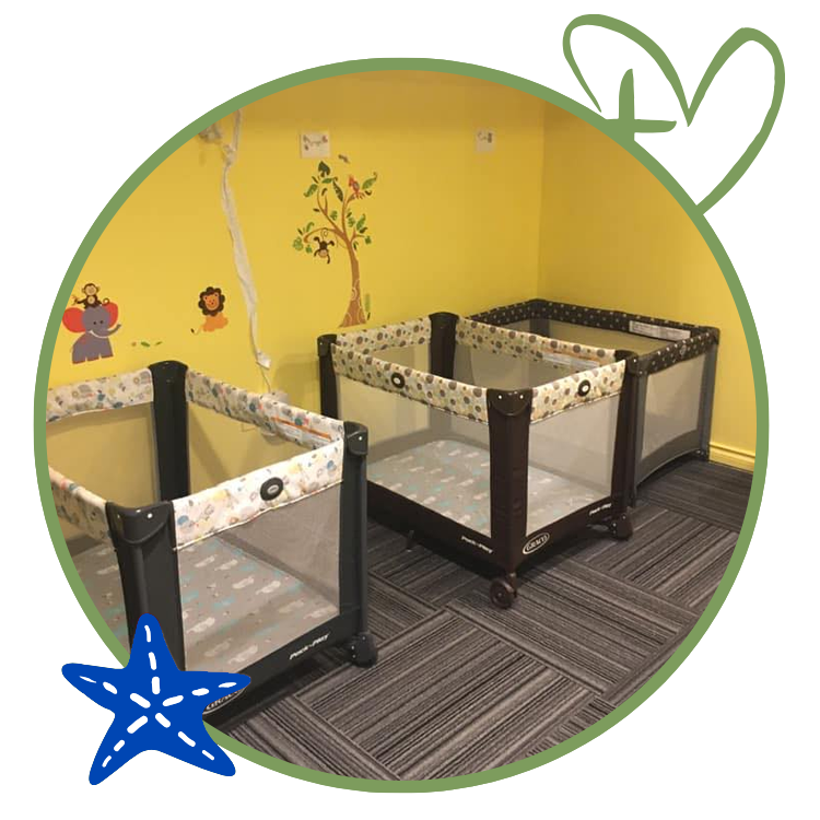 Three playards in a yellow-walled room with a tree decal and animal stickers.