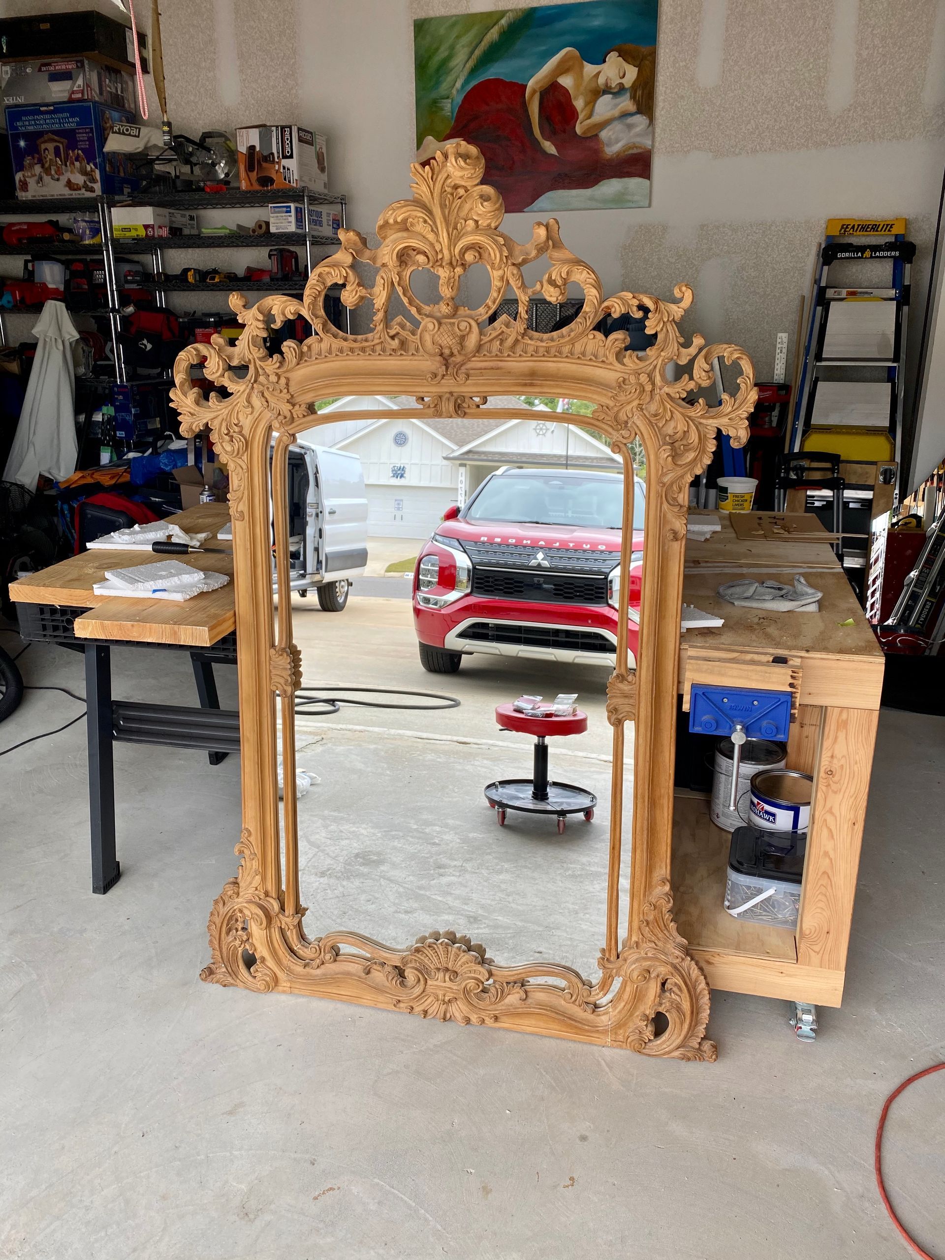 A car is reflected in a mirror in a garage