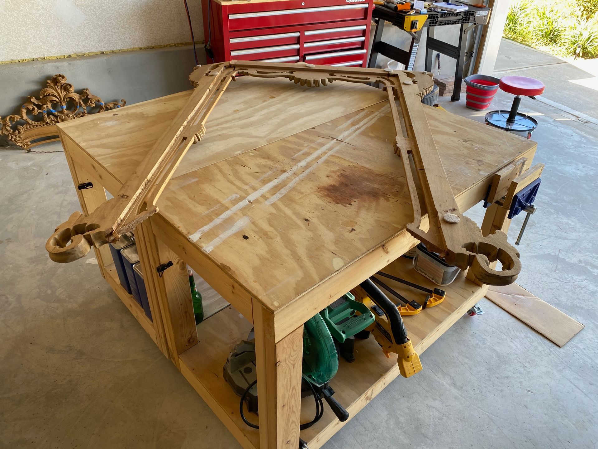 A wooden workbench in a garage with tools on it