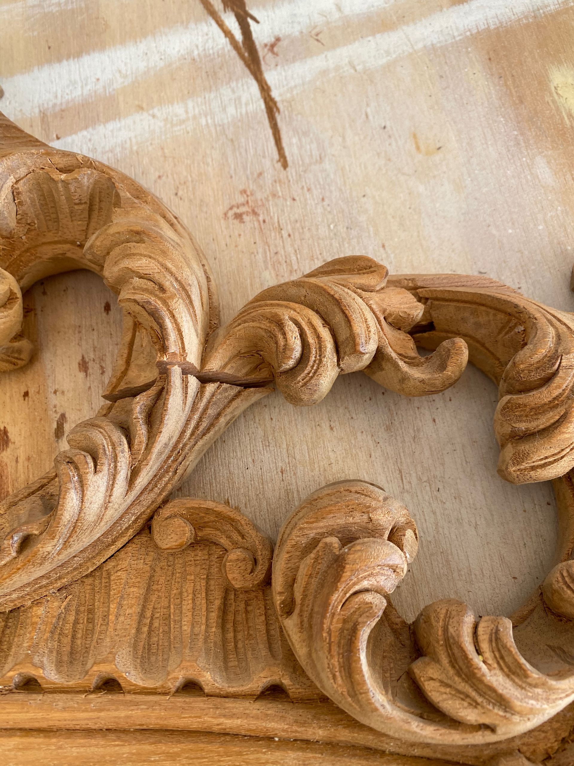 A close up of a wood carving on a table.