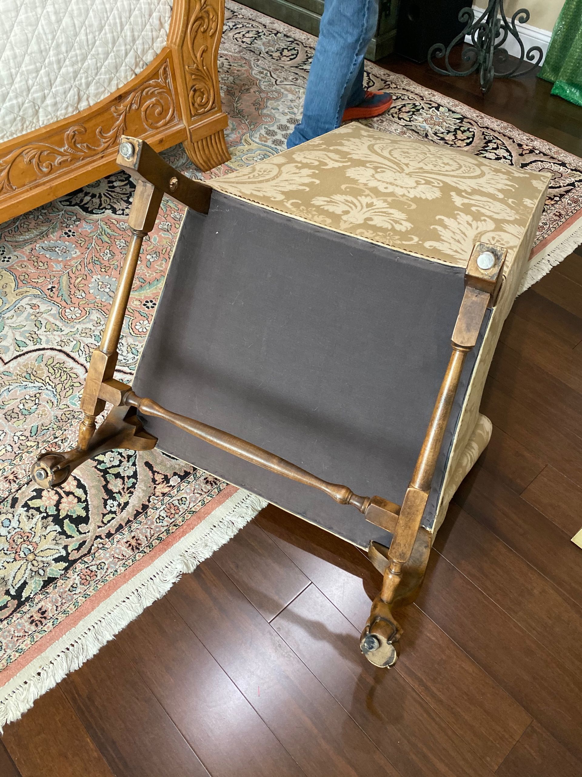 A chair is sitting on a wooden floor next to a rug.