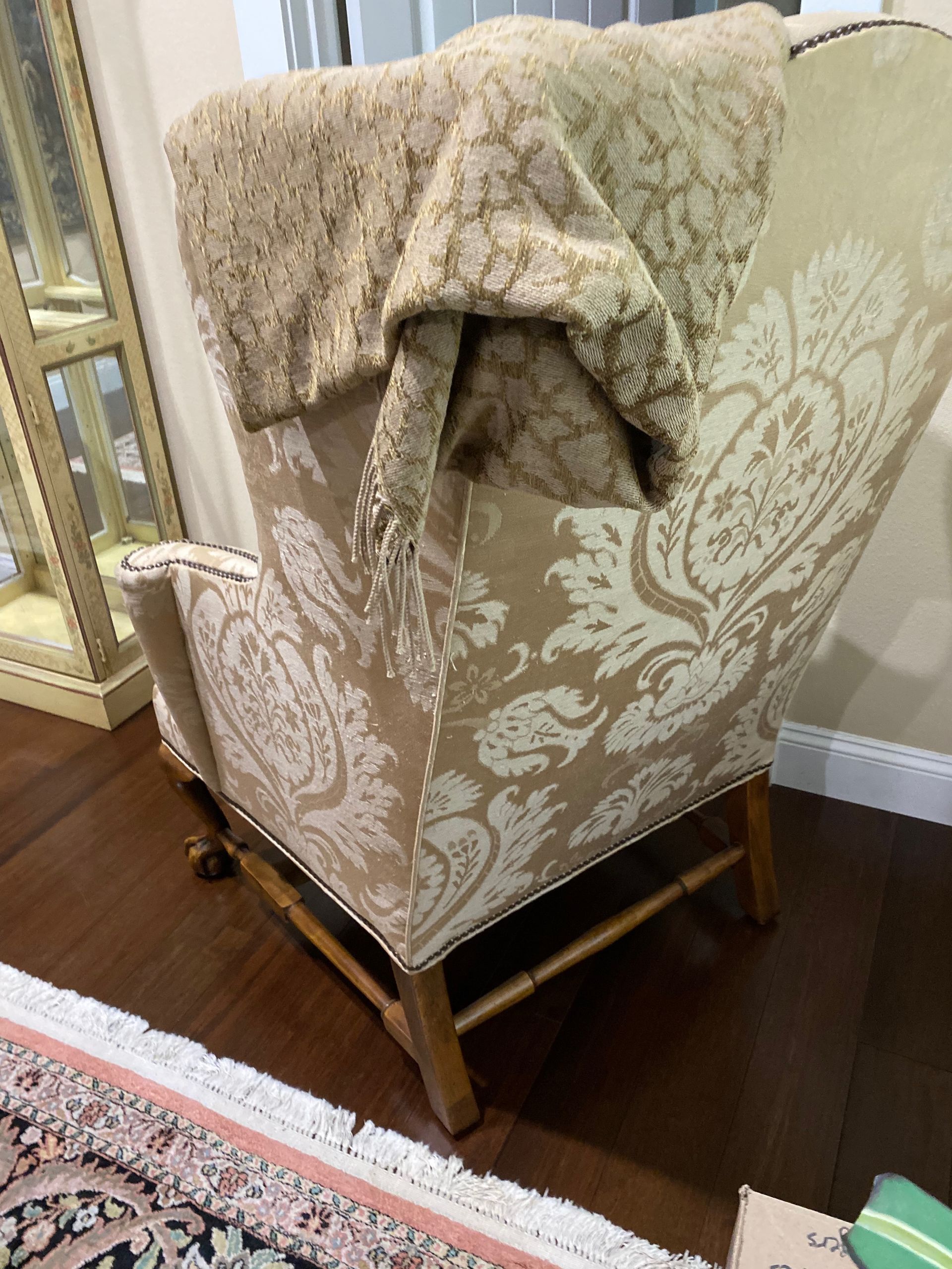 A chair with a blanket on it is in the living room.