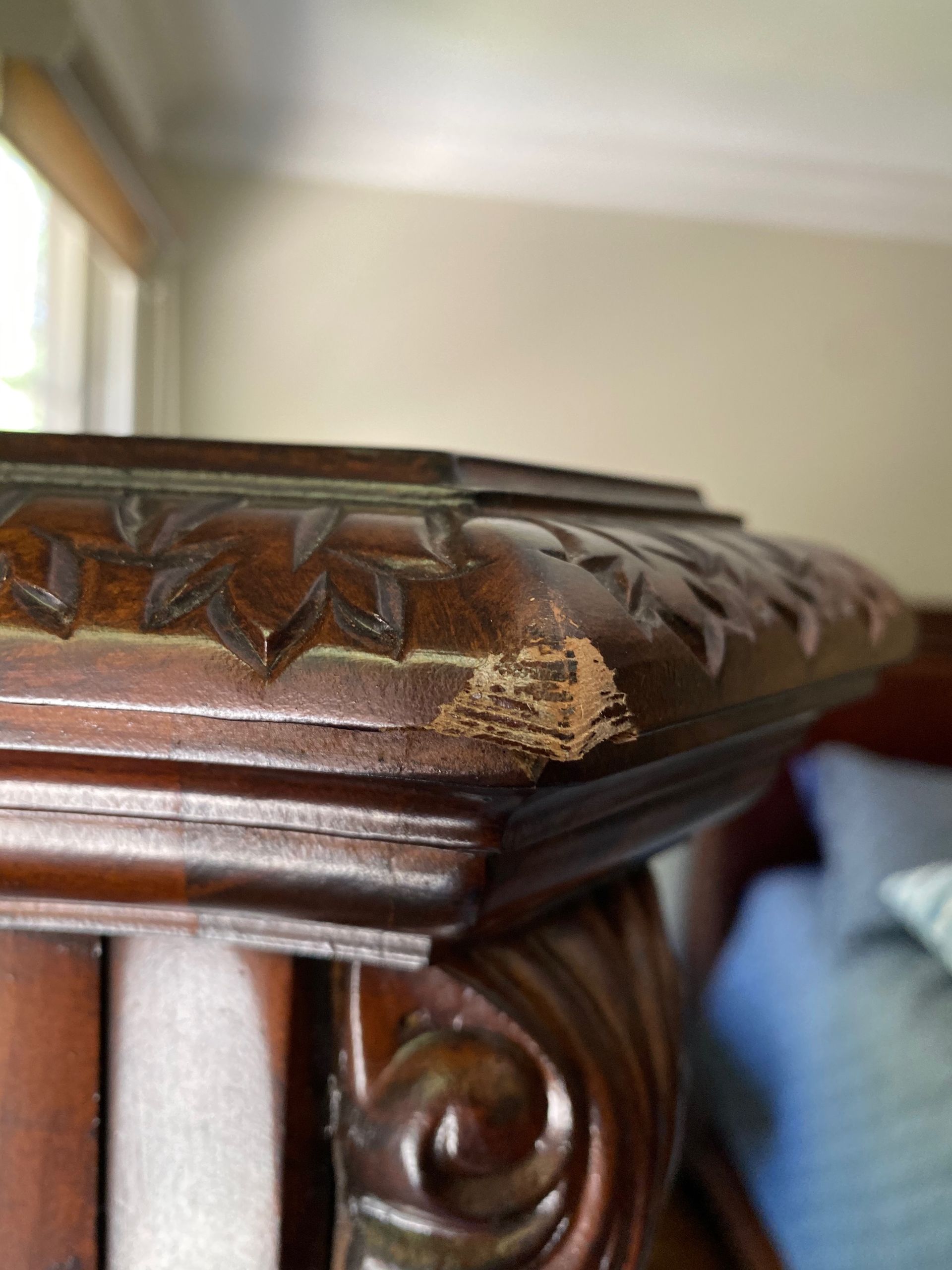 A close-up of a wooden table with a scratch on it