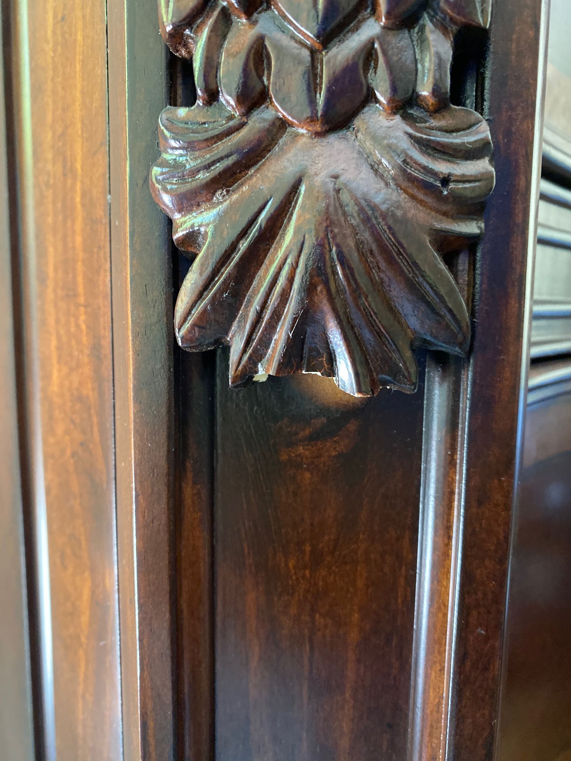 A close-up of a carved wooden piece of furniture