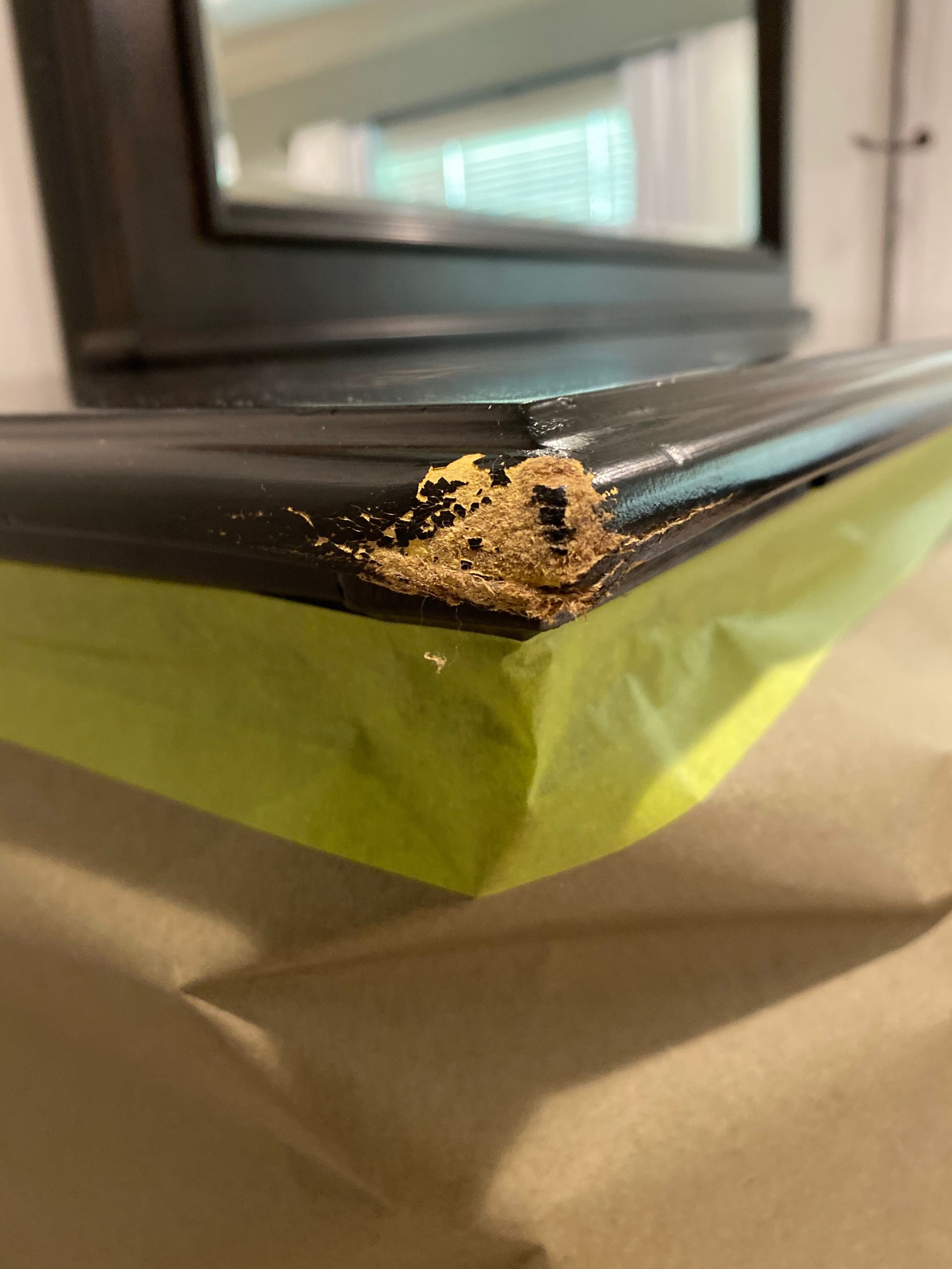 A close-up of a piece of wood with tape on it.