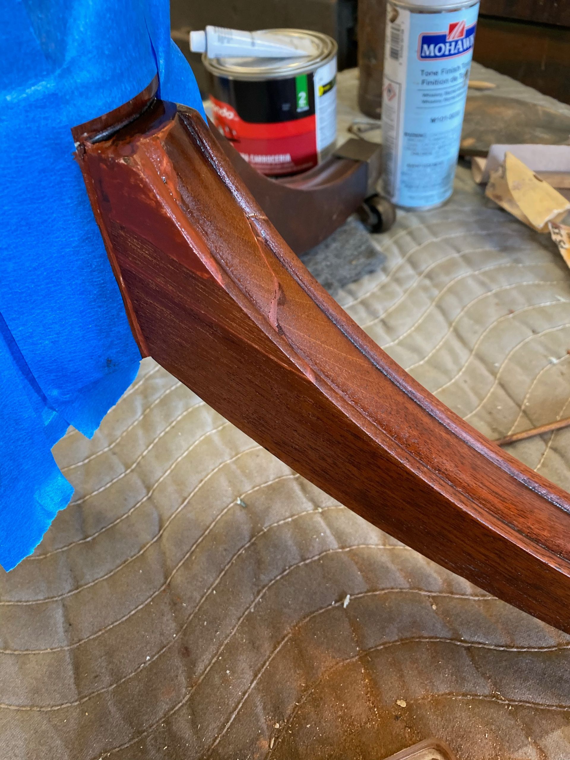 A piece of wood is being painted on a table.