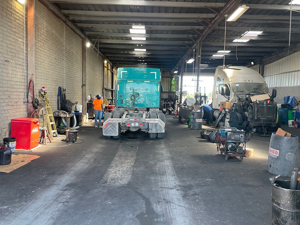 A large truck is parked in a large warehouse.