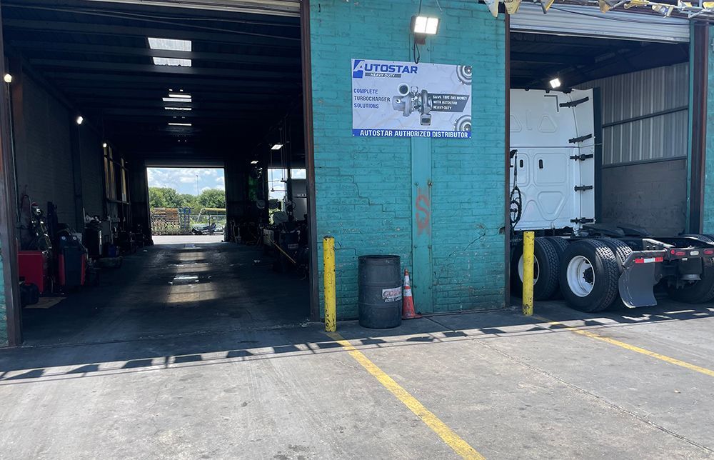 A truck is parked in a parking lot in front of a building.