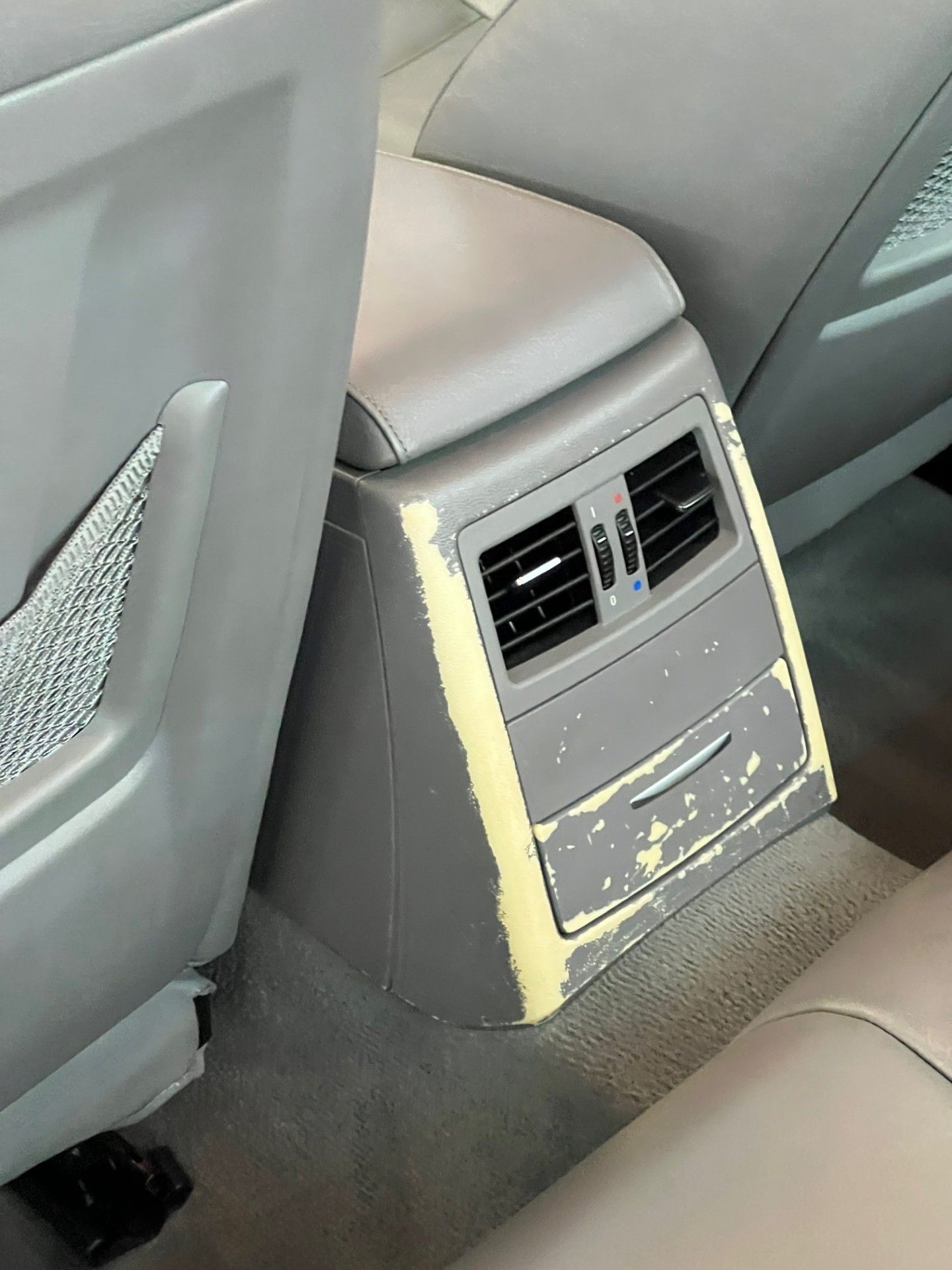 The back of a car with a damaged rear console.