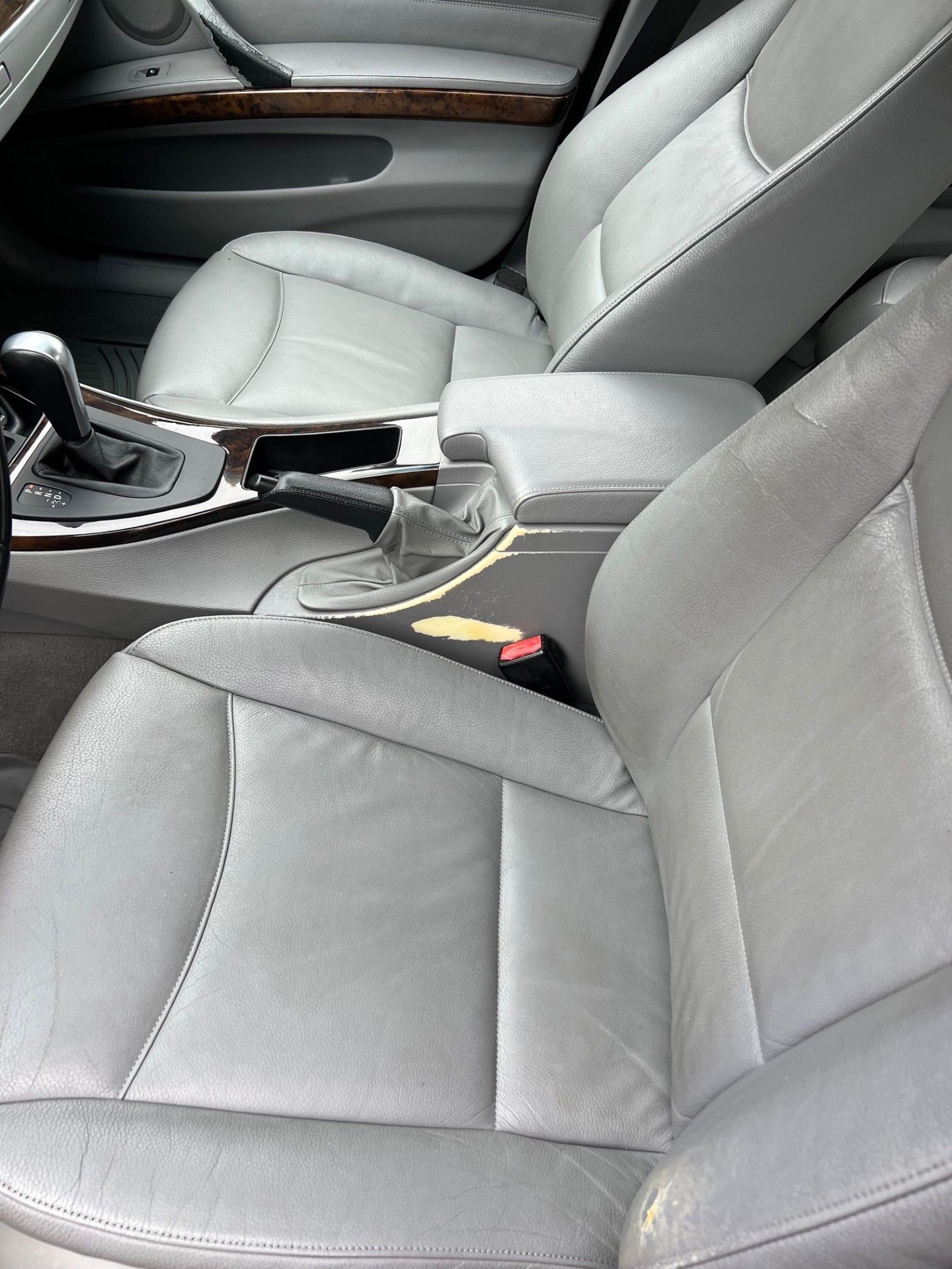 The interior of a car with gray leather seats.
