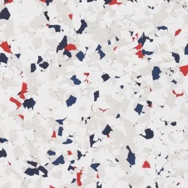 Speckled flooring with white, blue, and red flakes.