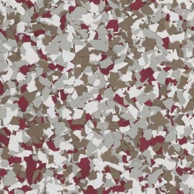 Close-up of a speckled flooring surface with maroon, white, gray, and brown chips.