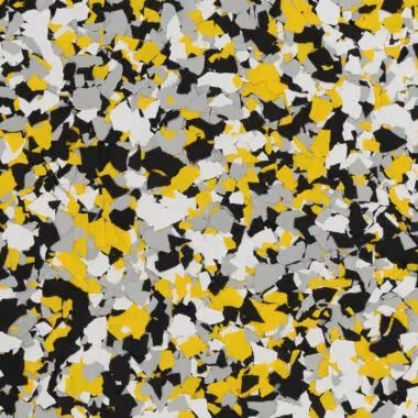 Close-up of a speckled floor coating with yellow, gray, black, and white chips.