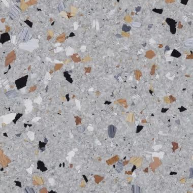 Close-up of a grey terrazzo surface with embedded chips of various colors, including black, white, and orange.