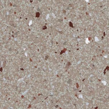 Tan speckled surface with red and white flecks, resembling terrazzo or a countertop.