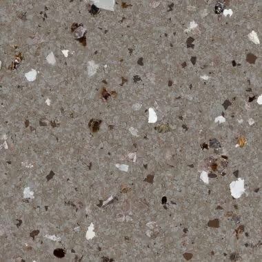 Close-up of speckled gray quartz countertop with white, brown, and black flecks.