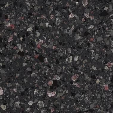 Dark gray speckled countertop surface with flecks of white and red.